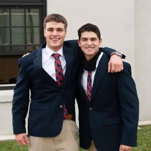 Two students in blue blazers standing together