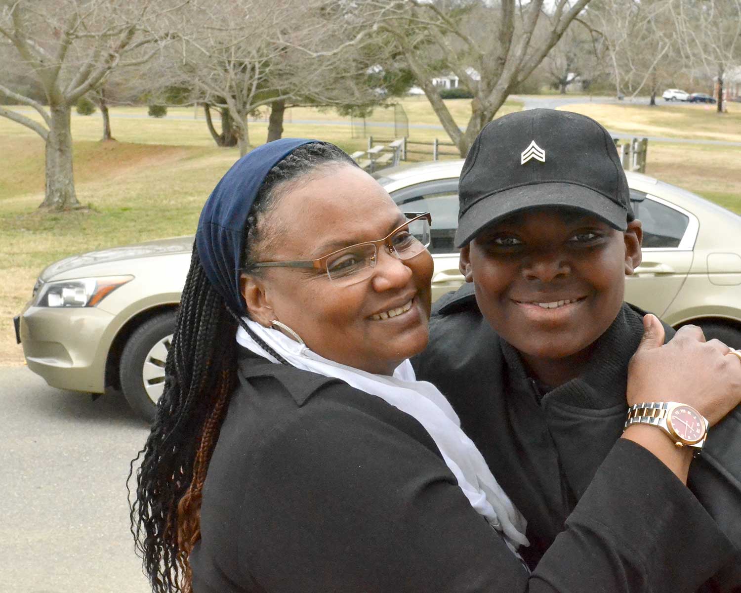 A happy cadet and mother prepare for leave departure