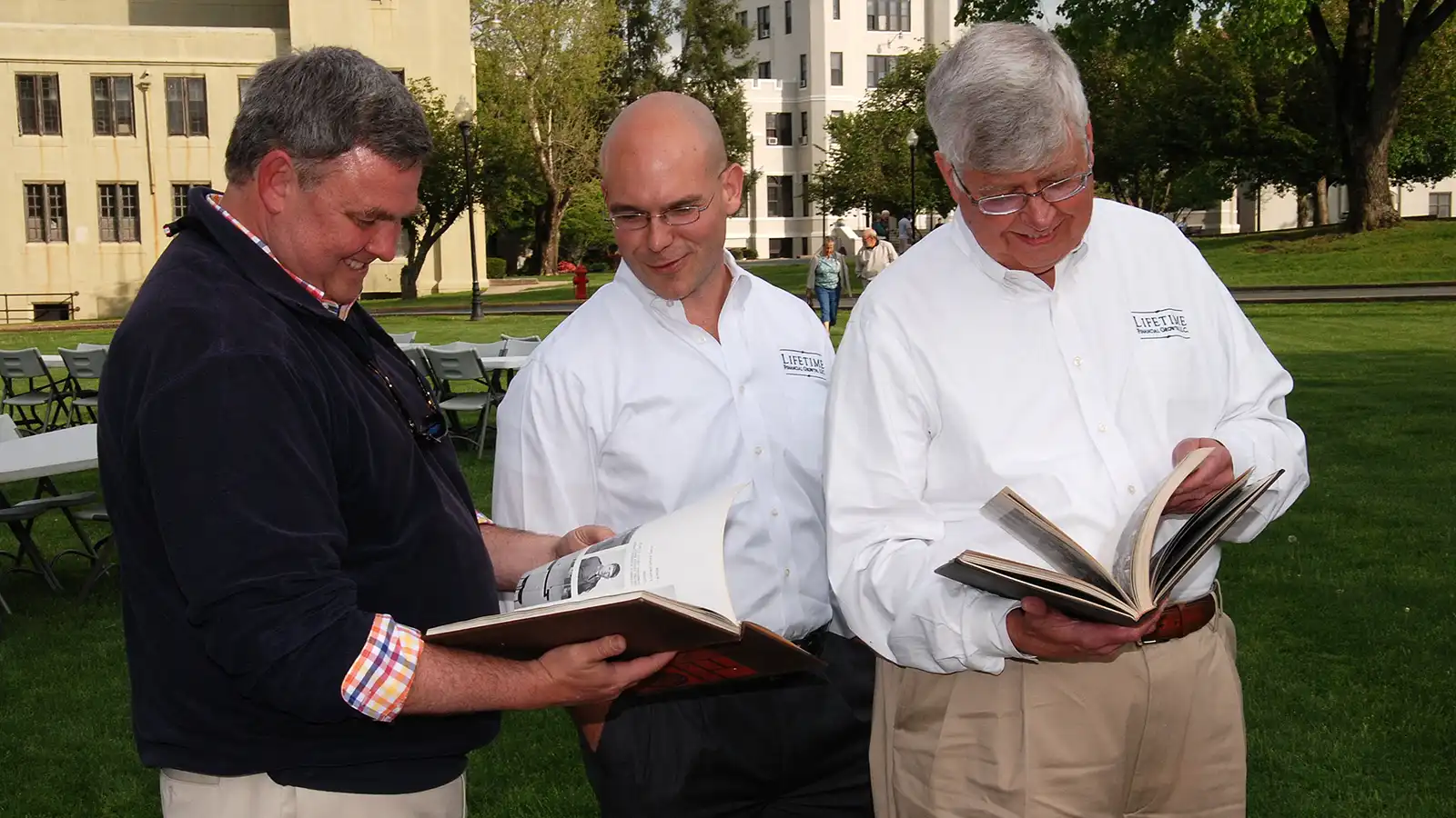 Alumni look through copies of the Skirmisher yearbook.